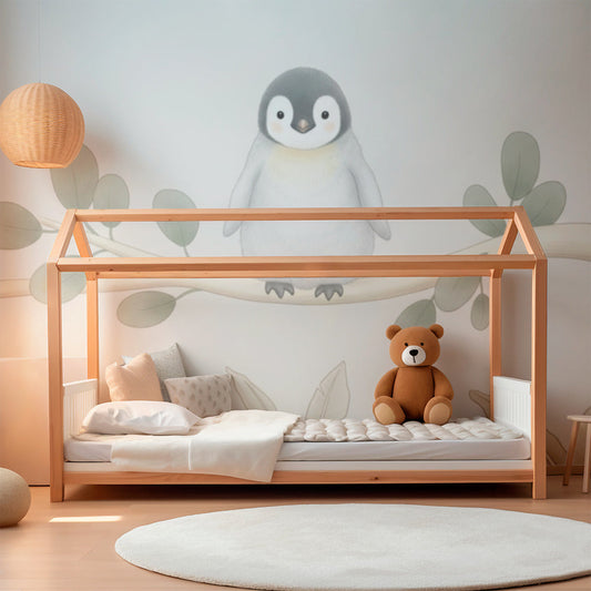 Kids-Mundo baby penguin eucalyptus branch wall mural featured on a kids bedroom wall behind a bed.
