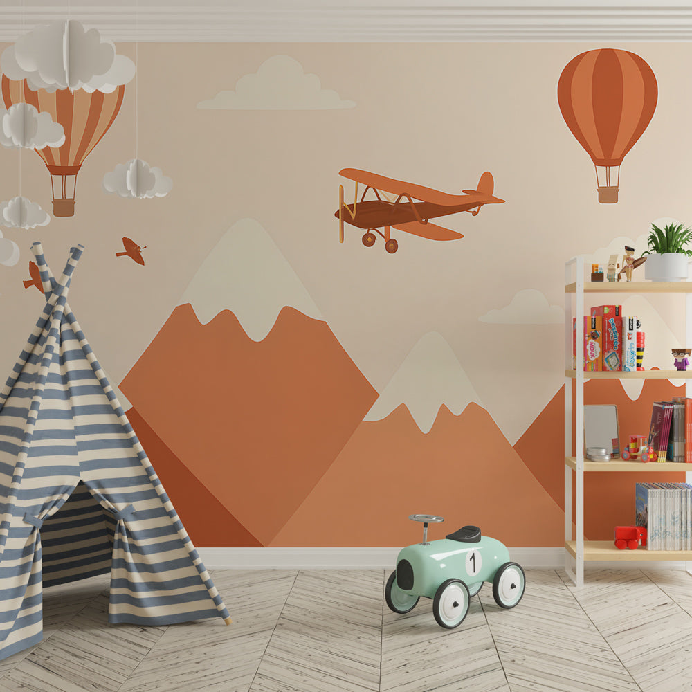 Children's bedroom featuring mountain adventure wallpaper with snowy peaks and flying elements