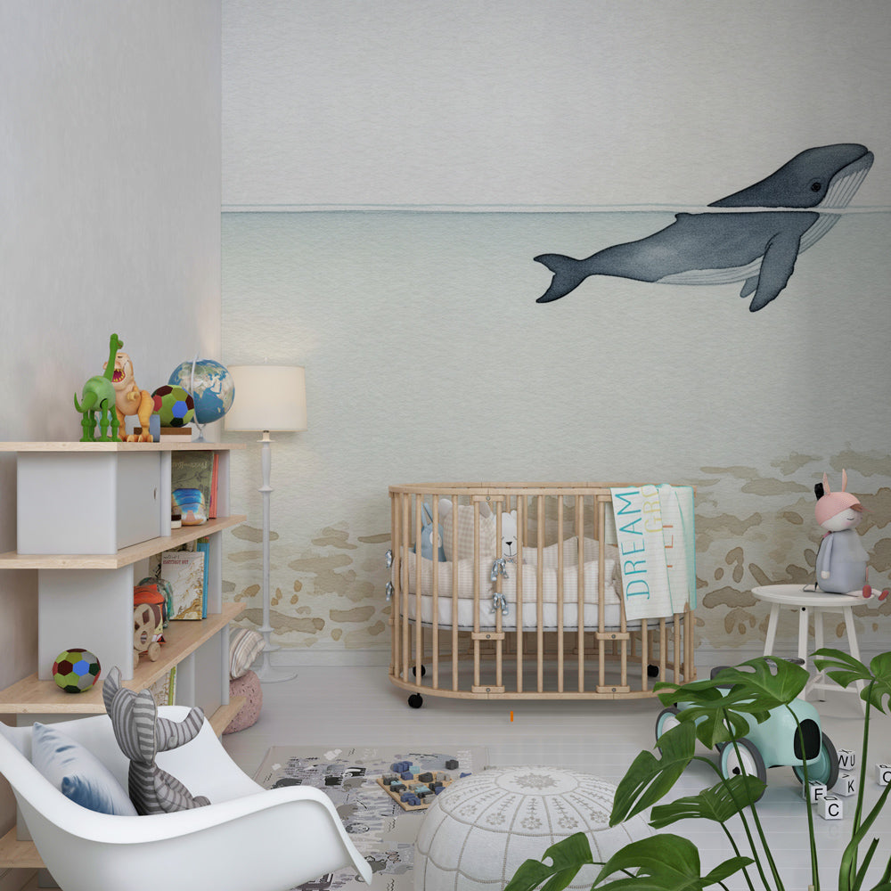 Underwater whale wallpaper creating peaceful children's bedroom atmosphere with ocean theme