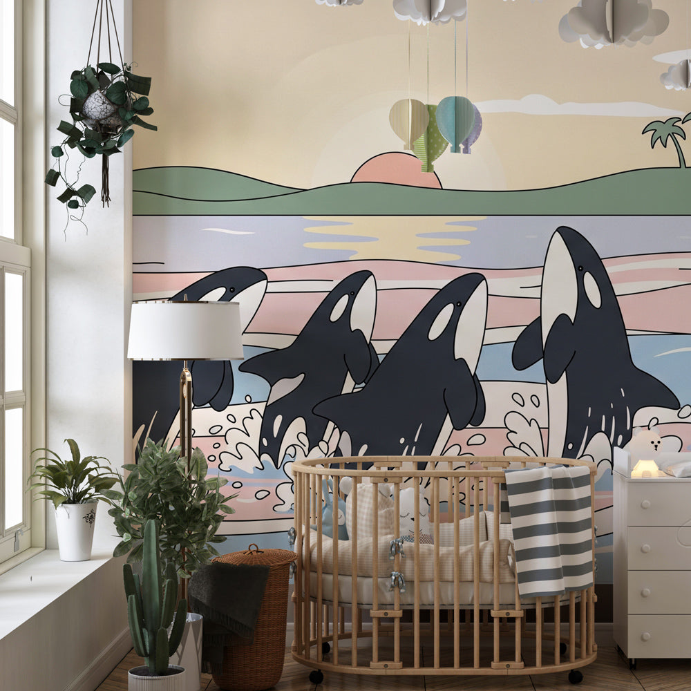 Playful whale mural wallpaper with sunset colors decorating peaceful nursery space