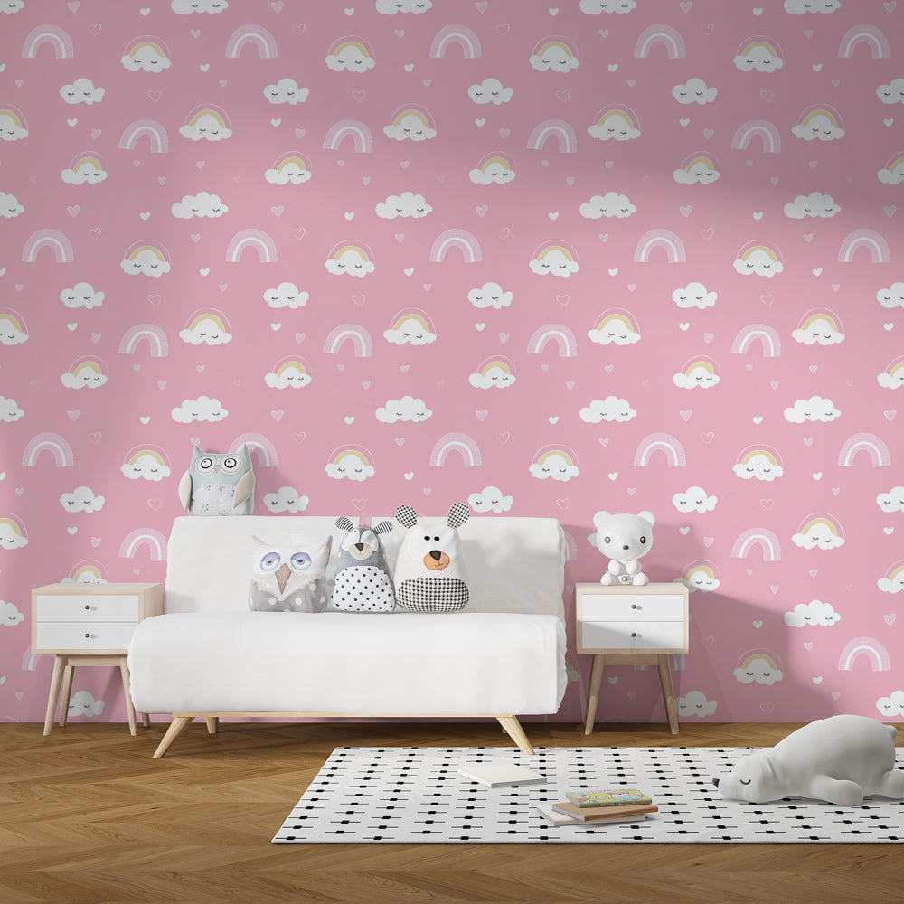 Smiling clouds and rainbow wallpaper decorating cozy toddler bedroom with pink accents