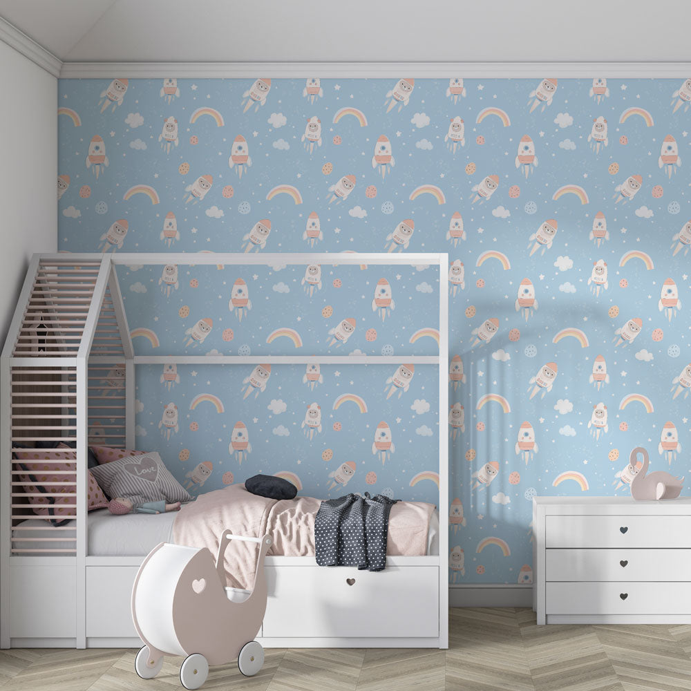 Blue astronaut wallpaper creating cosmic adventure theme in children's bedroom