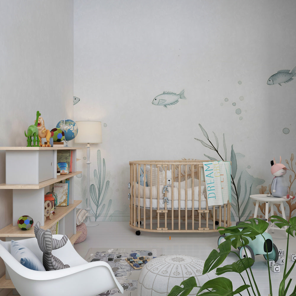 Ocean themed mural wallpaper creating calming underwater decor in children's playroom
