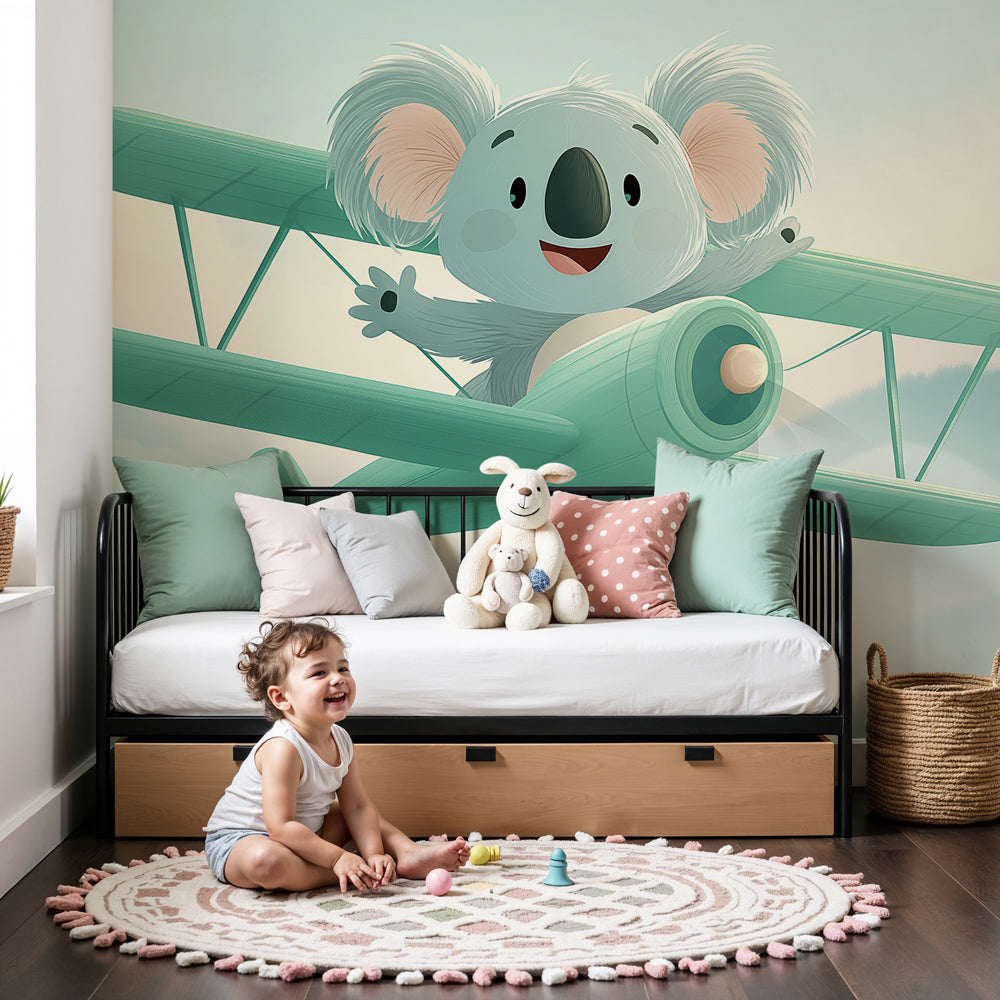 Adventure koala pilot mural wallpaper in modern nursery with natural wood furniture by Kids-Mundo