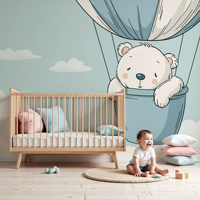 Baby bear hot air balloon mural wallpaper in modern nursery with wooden crib by Kids-Mundo