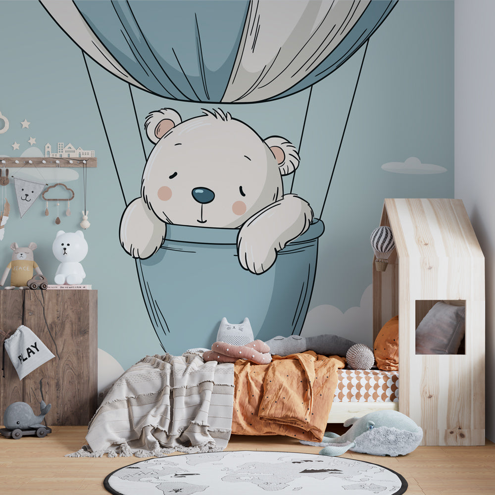 Hot air balloon bear wallpaper in cozy toddler bedroom with natural wood furniture