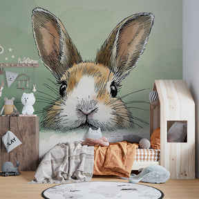 Gentle bunny mural wallpaper for baby room with natural nursery furniture and soft lighting