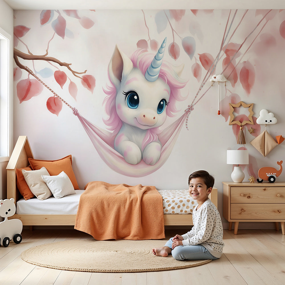 Kids-Mundo baby unicorn wall mural styled in a soft pink and white nursery with a cot.
