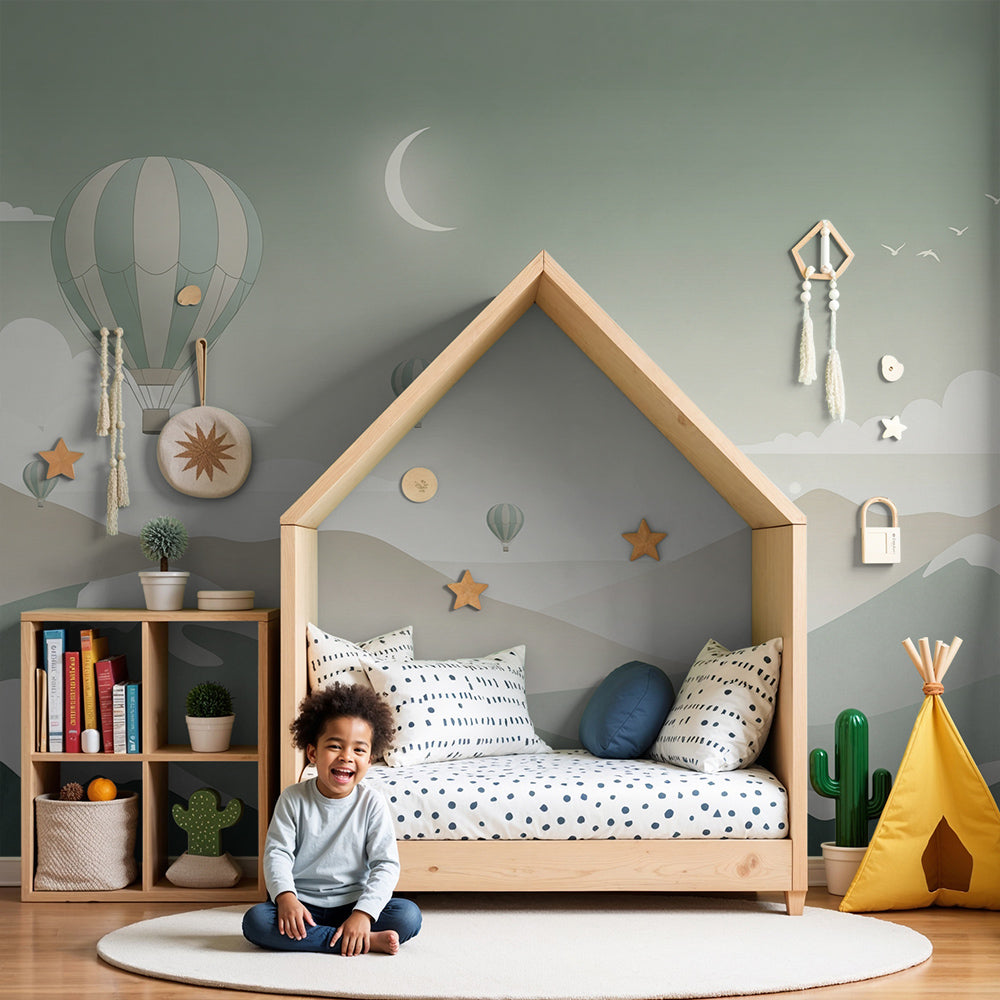 Kids-Mundo hot air balloon and moon wall mural above a cot in a soft nursery