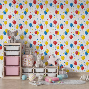 Festive balloon and stars mural wallpaper installed in bright children's bedroom setting