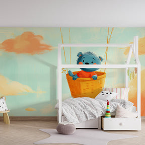 Pastel cloud bear wallpaper creating gentle adventure theme in children's playroom setting