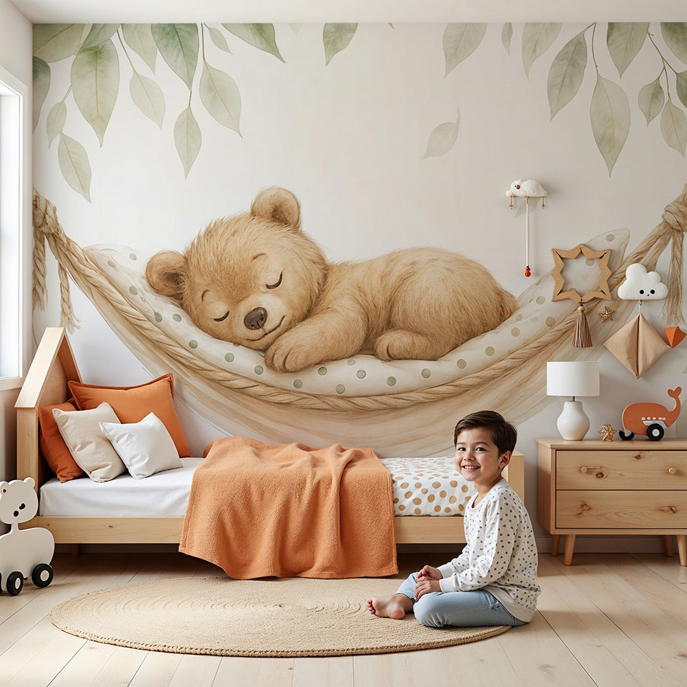Kids-Mundo sleeping bear cub hammock wall mural styled behind a cot in a warm, calm nursery