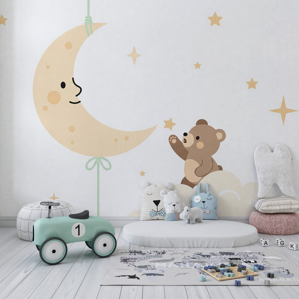 Dreamy bear and moon wallpaper in cozy children's bedroom with natural wood furniture