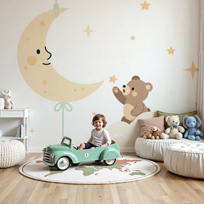 Bear moon mural wallpaper creating magical nursery atmosphere with wooden crib by Kids-Mundo