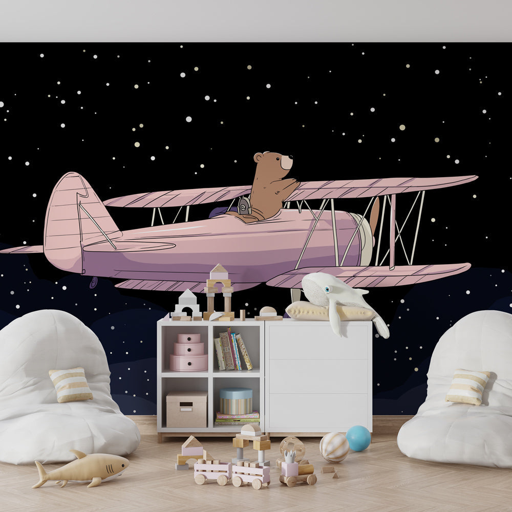 Whimsical bear and airplane mural wallpaper in cozy toddler room setting