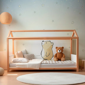 Dreamy night sky mural wallpaper featuring teddy bear and stars in cozy toddler room setting
