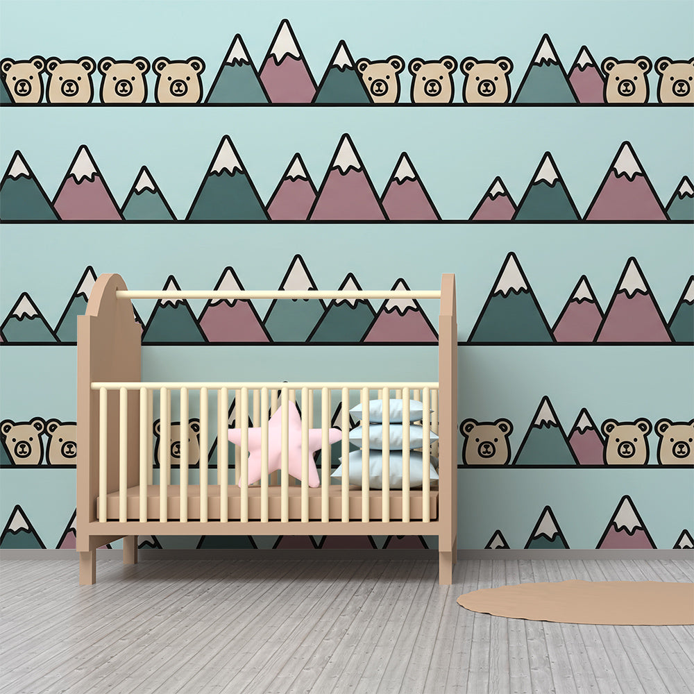 Kids-Mundo mountain wall mural styled in a kids bedroom, bringing a cosy teal and mauve mountain scene to the wall.