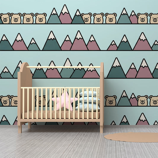Kids-Mundo mountain wall mural styled in a kids bedroom, bringing a cosy teal and mauve mountain scene to the wall.