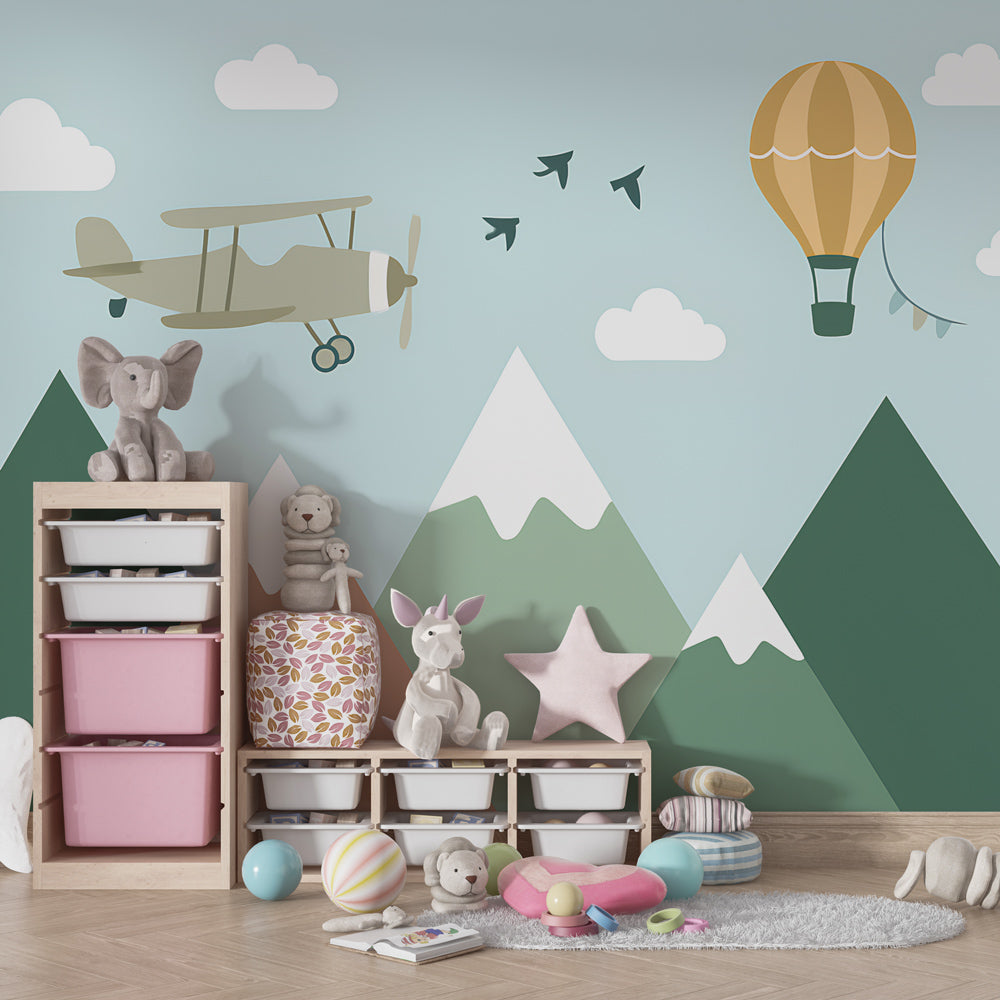 Kids-Mundo biplane and balloon mountain wall mural behind a bed in a kids bedroom.