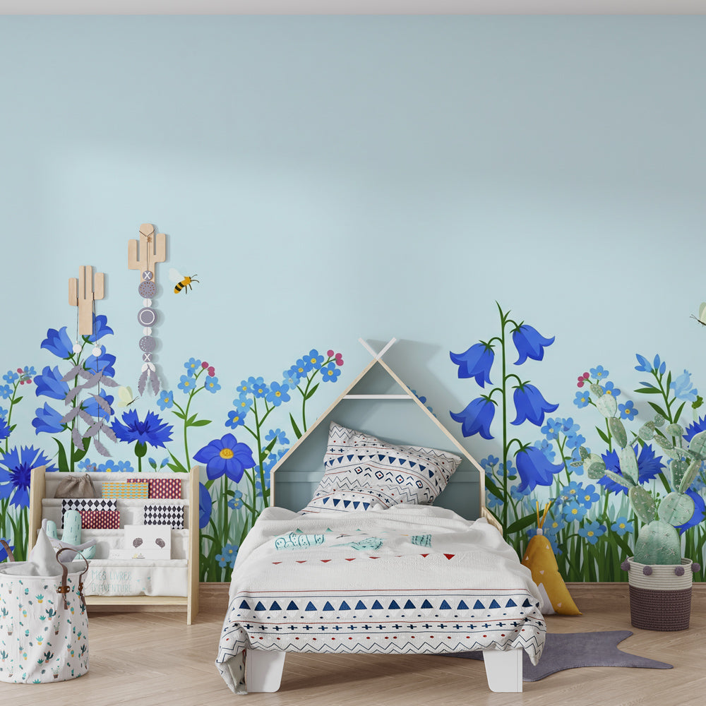 Children's bedroom featuring blue flowers and bees mural wallpaper with natural wooden furniture