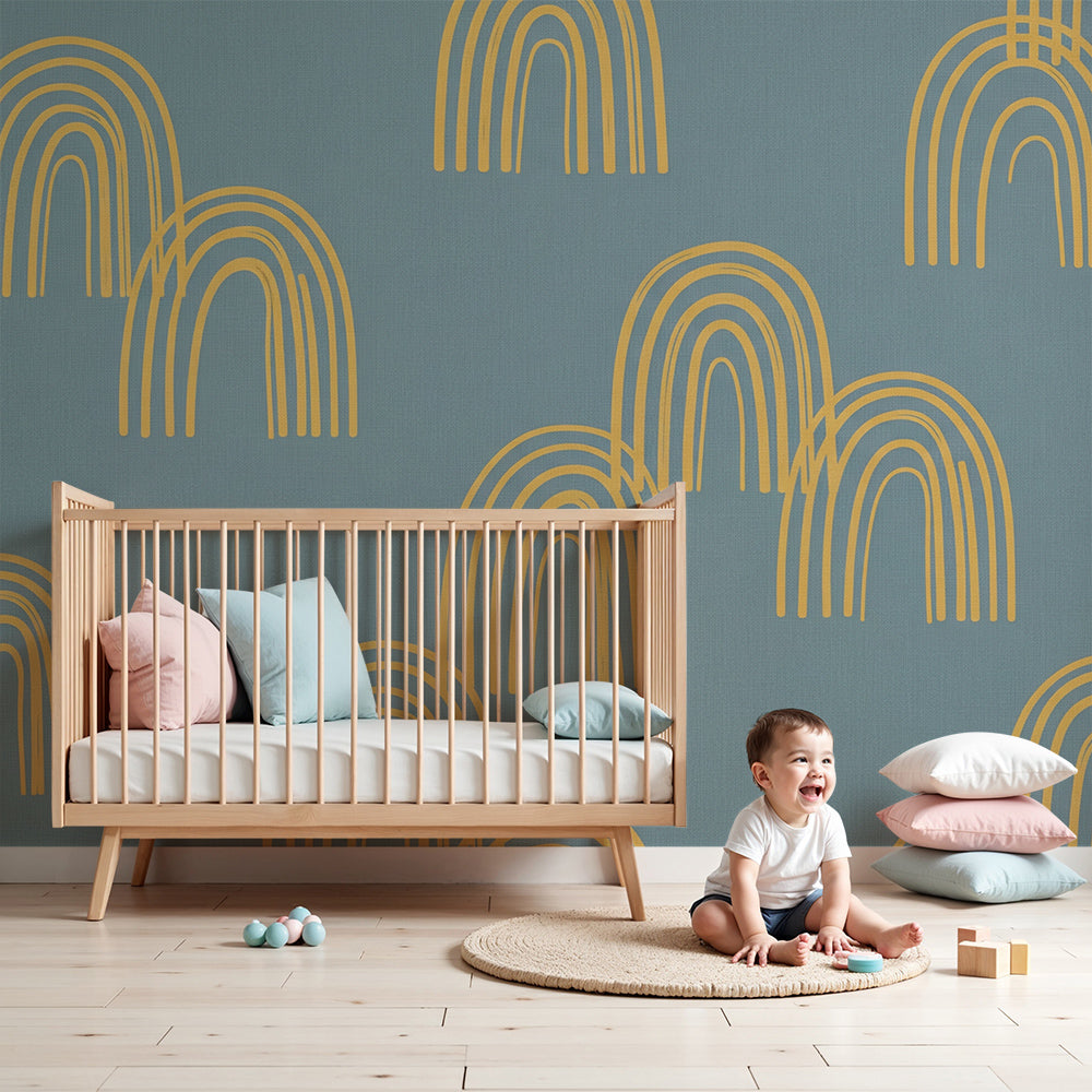 Nursery wall featuring the Kids-Mundo blue linen-look rainbow arch wall mural in mustard tones