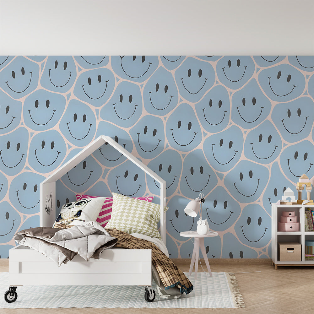 Kids-Mundo blue smiley face wall mural covering a playroom wall with toys and floor cushions