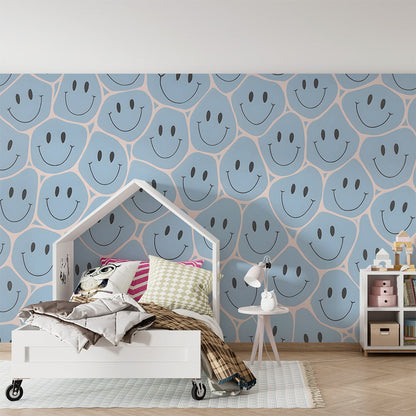 Kids-Mundo blue smiley face wall mural covering a playroom wall with toys and floor cushions
