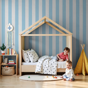 Blue striped mural wallpaper in modern nursery with soft lighting by Kids-Mundo
