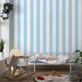 Soft blue striped mural wallpaper in kids playroom with natural light and toys by Kids-Mundo