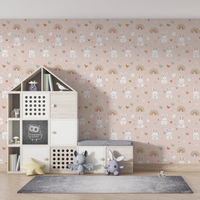Cute bunny and rainbow wallpaper creating magical kids bedroom decor with natural wood furniture