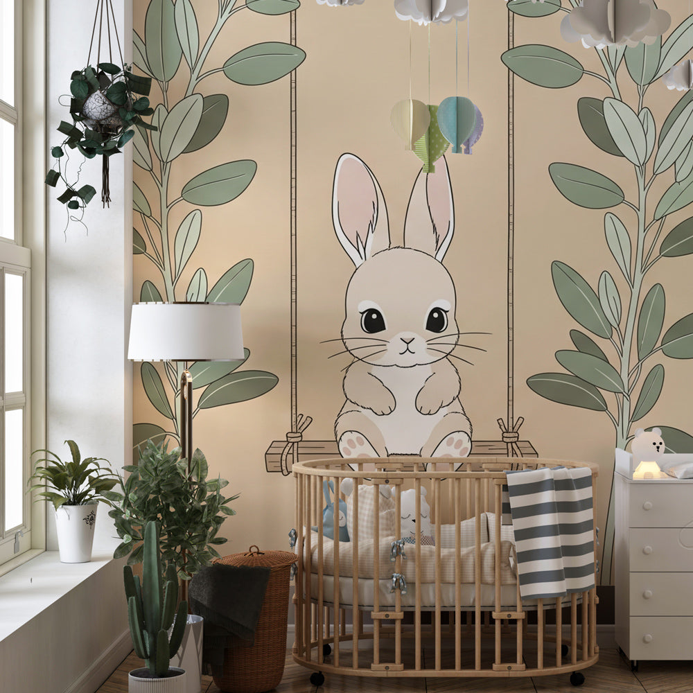 Soft green and beige bunny mural wallpaper complementing light wood nursery furniture
