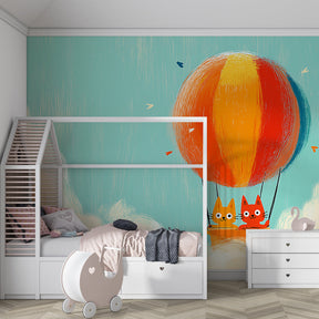 Whimsical cat balloon wallpaper creating imaginative play environment in bright kids playroom