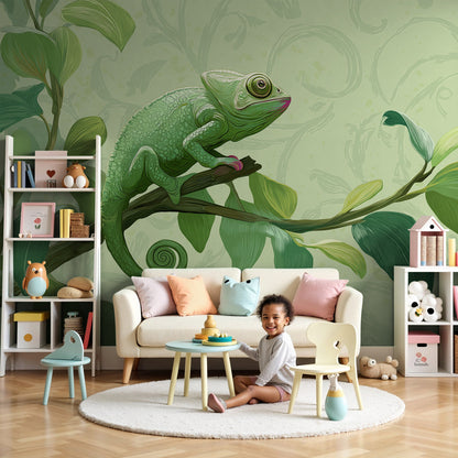 Kids-Mundo chameleon wall mural on a leafy branch styled behind a cot in a calm green nursery.