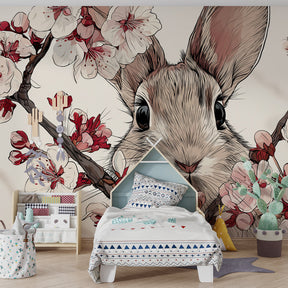 Serene baby room featuring cherry blossom rabbit wallpaper with soft pastel decor