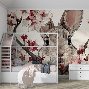 Cherry blossom mural wallpaper creating peaceful nursery atmosphere with bunny design