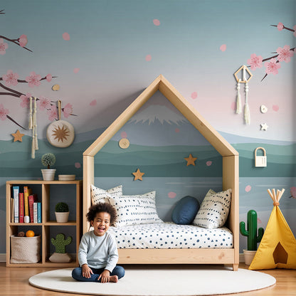 Kids-Mundo cherry blossom mountain lake wall mural styled behind a cot in a soft pink nursery