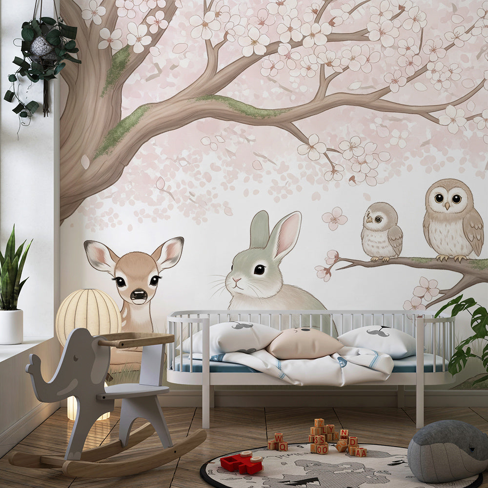 Kids-Mundo cherry blossom wall mural in a bright playroom, featuring a fawn, bunny and two owls.