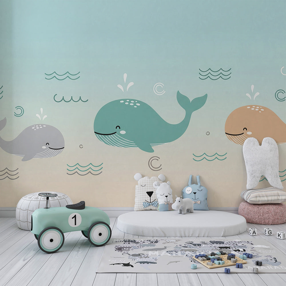 Kids-Mundo pastel whales mural covering a playroom wall, made-to-measure sea-themed wallpaper.