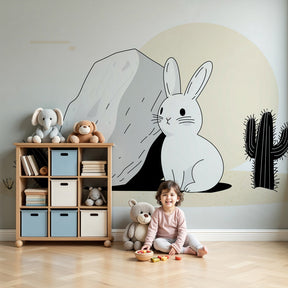 Desert bunny mural wallpaper creating cozy nursery atmosphere with natural wood crib by Kids-Mundo