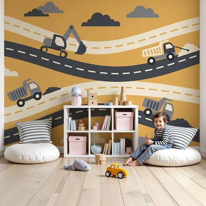 Kids-Mundo digger and dump truck wall mural with winding roads in a bright toddler nursery.