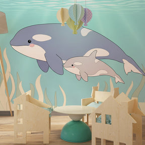 Playful dolphins mural wallpaper with coral and seaweed in bright kids room by Kids-Mundo