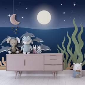 Ocean themed wallpaper with dolphins and moonlight in cozy children's room decor