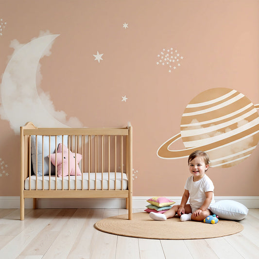 Kids-Mundo moon and planet wall mural above a cot in a soft dusty-pink nursery