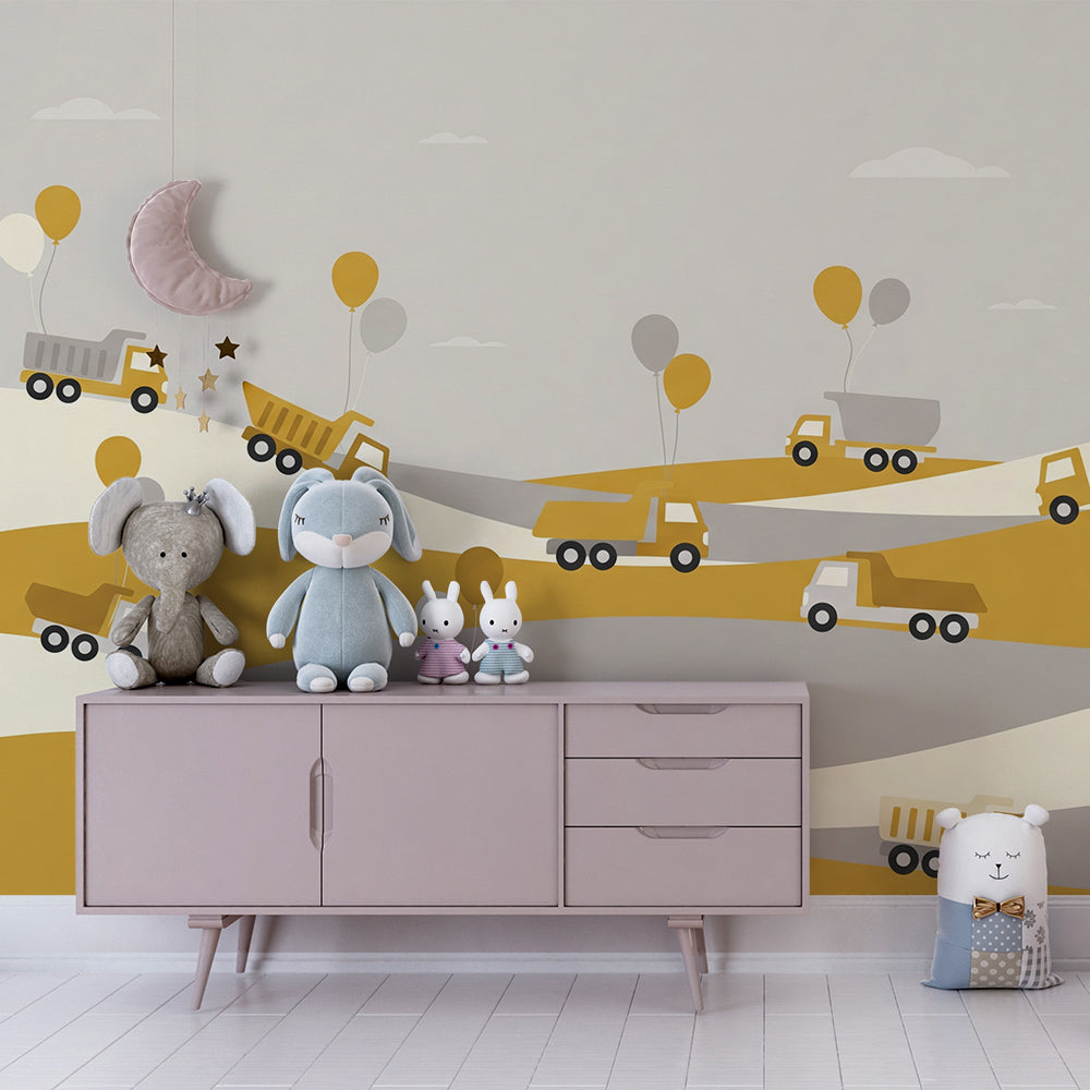 Kids-Mundo dump truck balloon wall mural behind a bed in a cheerful mustard kids bedroom.