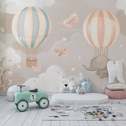 Kids-Mundo hot air balloon and elephant wall mural in a pastel pink and blue kids' bedroom setting.