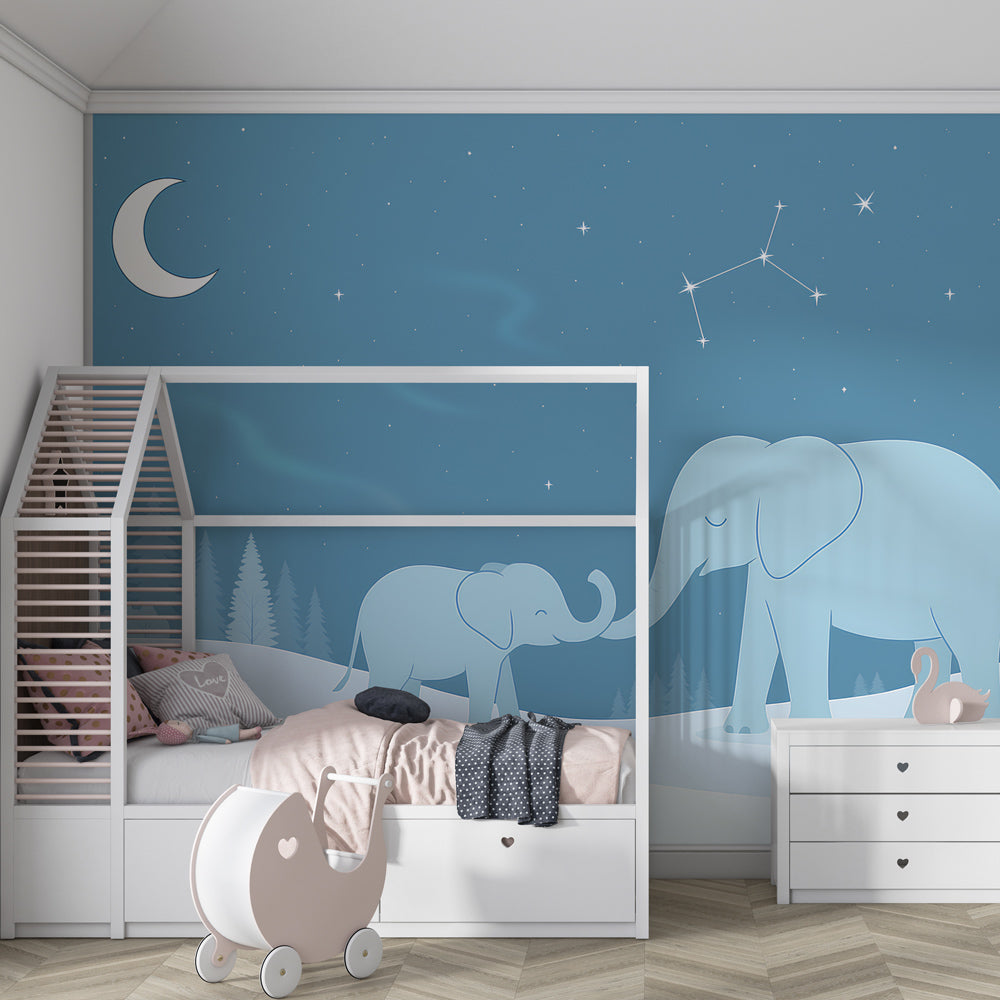 Starry elephant mural wallpaper in modern children's bedroom with soft blue tones and wooden furniture