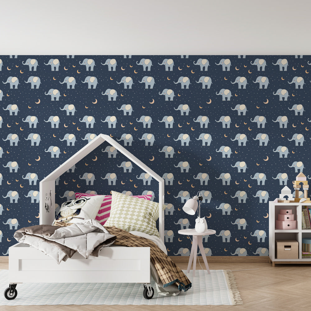 Navy blue elephant mural wallpaper with crescent moons in cozy kids room setting