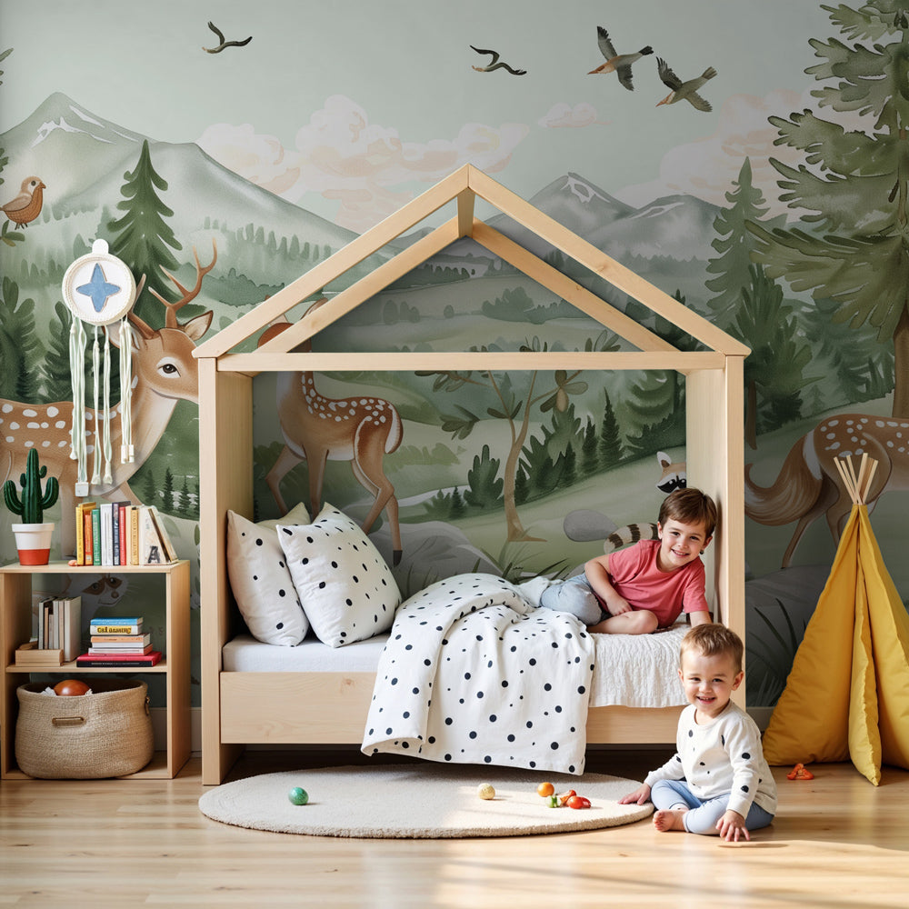 Kids-Mundo enchanted forest deer wall mural styled behind a cot in a soft green nursery