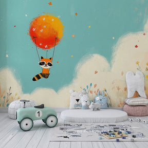 Animal-themed nursery with flying raccoon mural wallpaper featuring clouds and flowers by Kids-Mundo