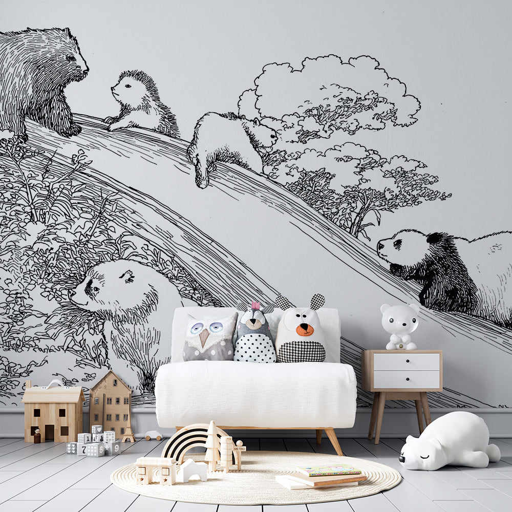 Kids-Mundo woodland wall mural in a playroom, featuring forest animals playing on a grassy hillside slide